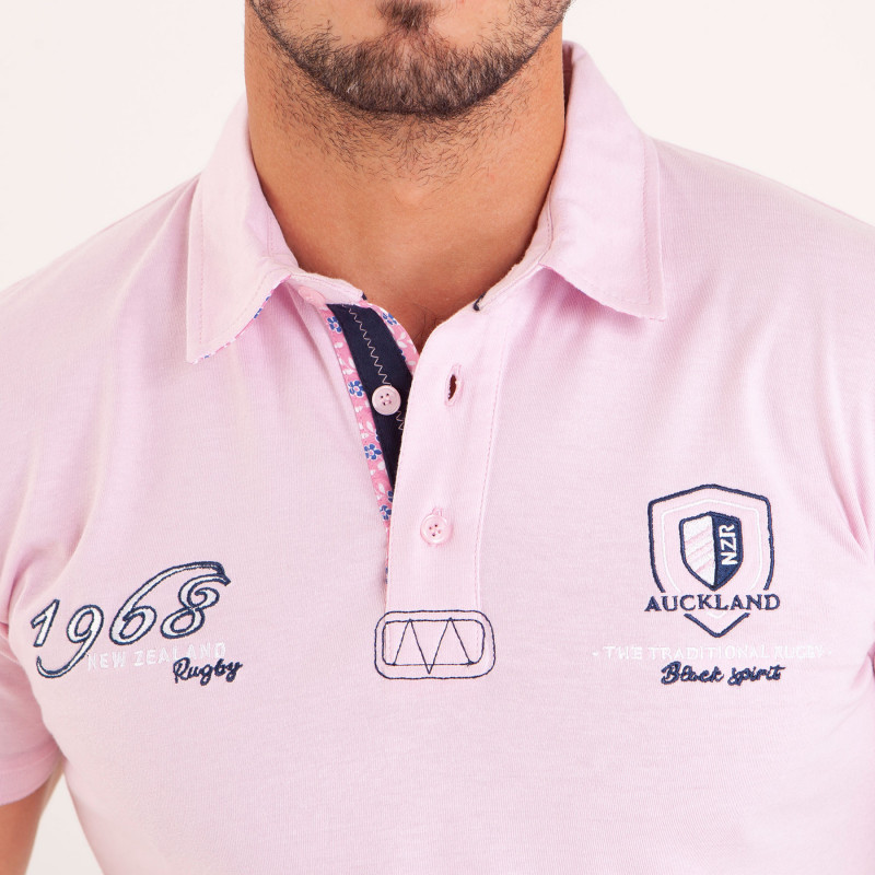 Polo uni détails col et broderies poitrine