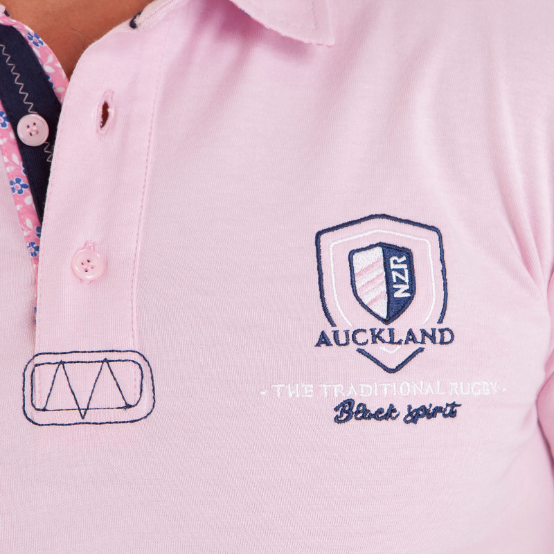 Polo uni détails col et broderies poitrine