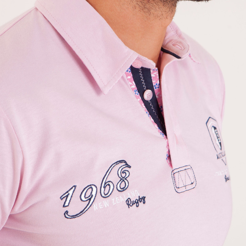 Polo uni détails col et broderies poitrine