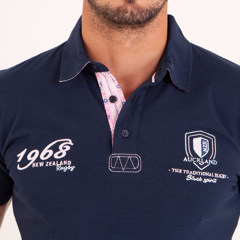 Polo uni détails col et broderies poitrine