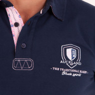 Polo uni détails col et broderies poitrine