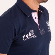 Polo uni détails col et broderies poitrine