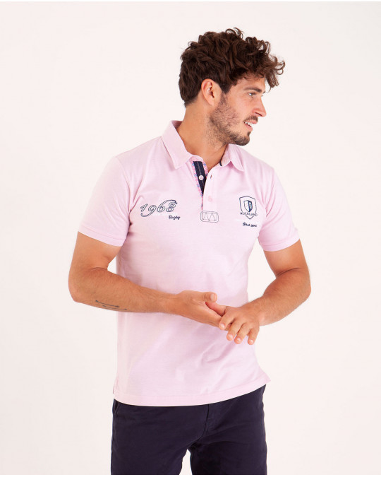 Polo uni détails col et broderies poitrine