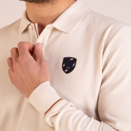 Polo manches longues avec écusson en maille cloquée